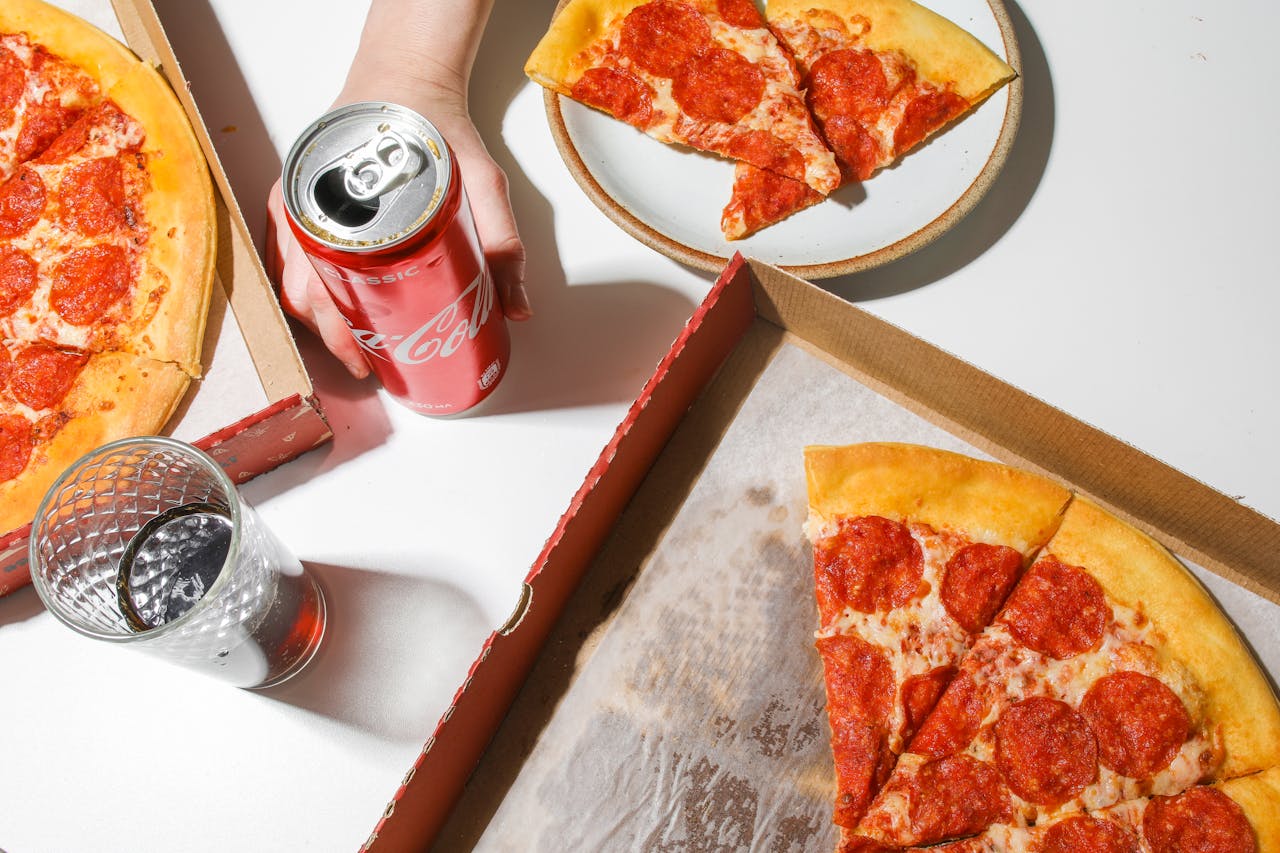 services-01 Delicious pepperoni pizza with soda, ideal for fast food lovers.